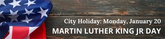 Dark wood background with an American flag and text that Monday, January 20 is City holiday.